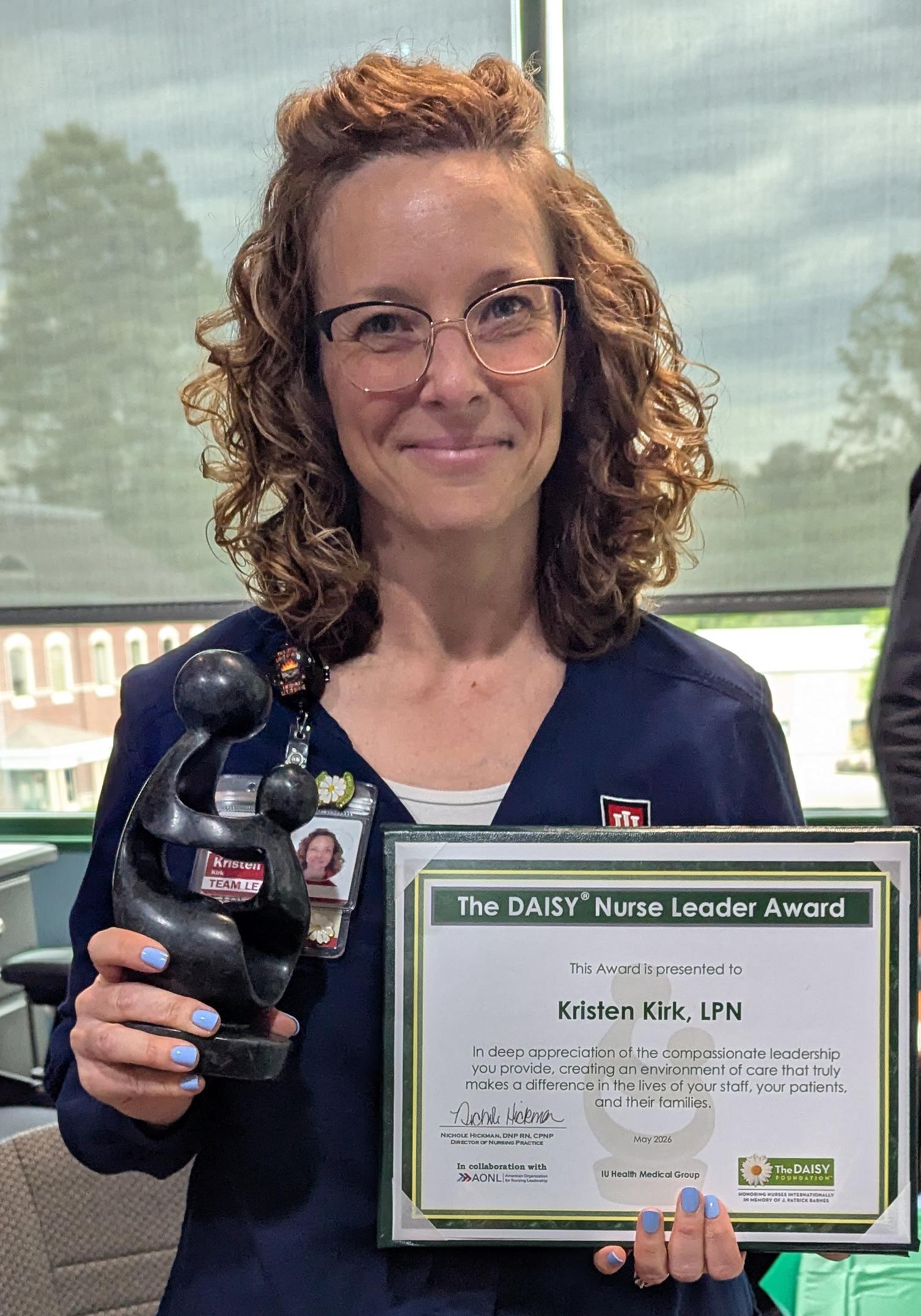 IU Health Ear, Nose and Throat (ENT) Team Lead Kristen Kirk, LPN, with her DAISY Award statue and certificate