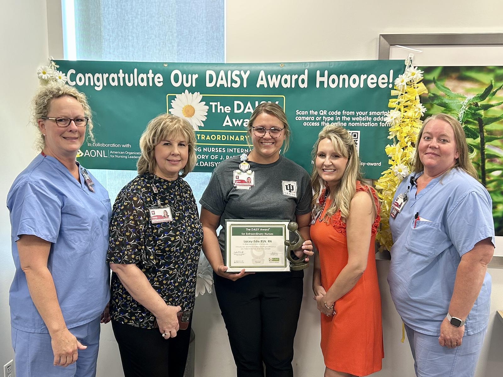 Lacey Edie, RN, with her DAISY Award and IU Health Bloomington leadership
